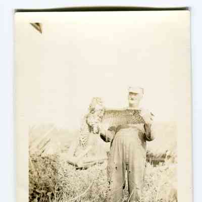 Postcard of George Dodge holding an owl