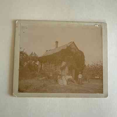 Photo of an old house covered with vines