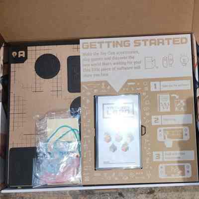 Game Box - Open: Game Card, Pre-cut Cardboard Pieces, Various Parts and Accessories