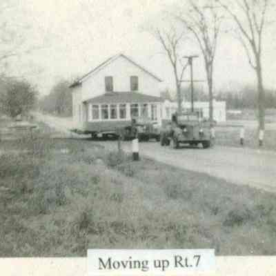 2023.21.1.4 Sinnott home moving up Route 7. The building in the background right is the current location of Le Marche and Monell Shelburne stores.