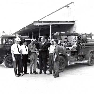 Men in Front of Firetrucks