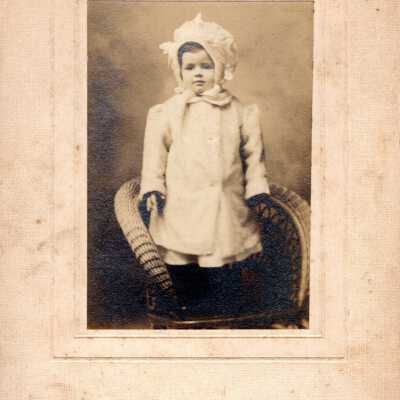 Portrait of a Child Standing on a Chair