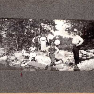 Group of Ten People by a River