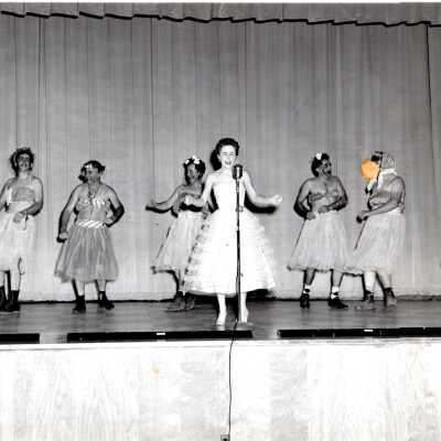 Photo of a Group of People Performing on Stage