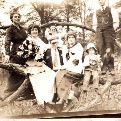Men, Women and Child on Tree Branch