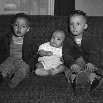 Three kids on a sofa