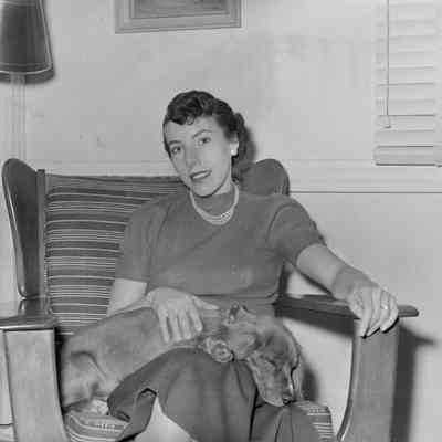 Woman on chair with sleeping dog