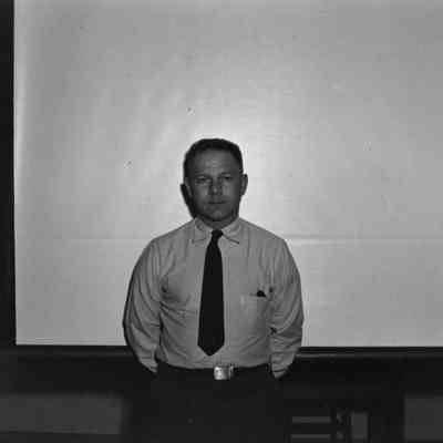 Man standing in front of projector screen
