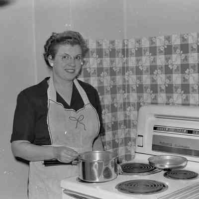 Woman in front of a stove