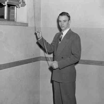 Man opening blinds