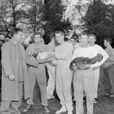 Group of men with a rooster