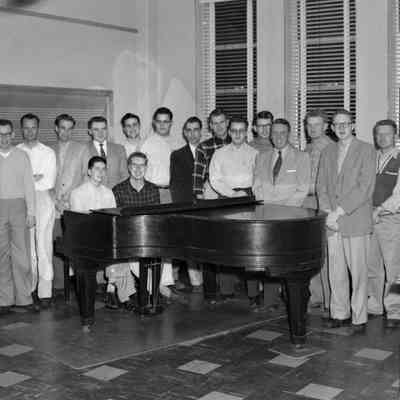 Male group photo at piano