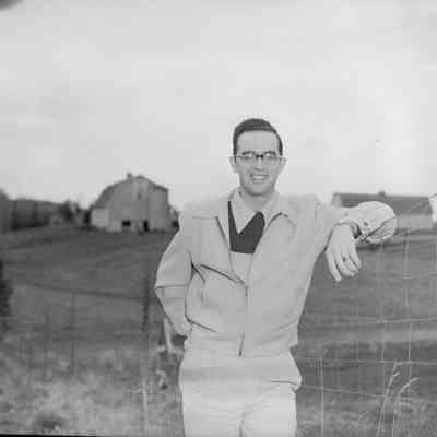 Man posing at fence