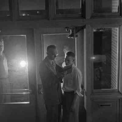 Men in doorway reading