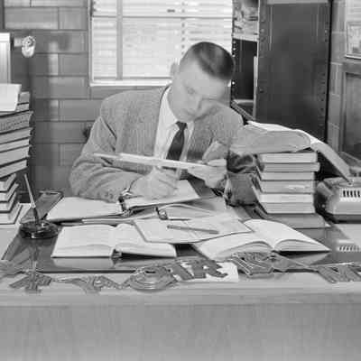 Man looking at slide rule
