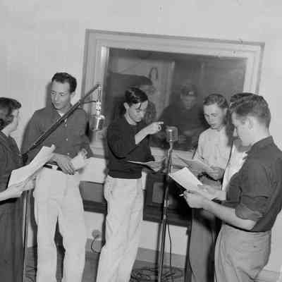 A group of young people in a recording booth