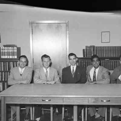 Five men at a table