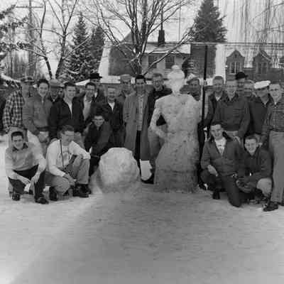 A group of young men with a snowwoman