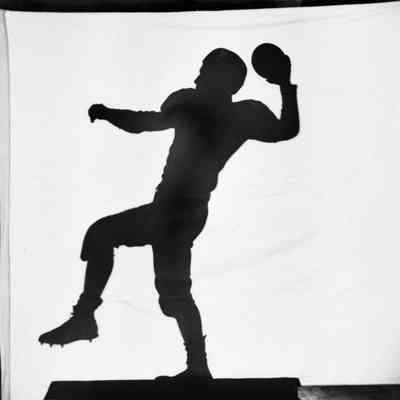 Silhouette throwing football