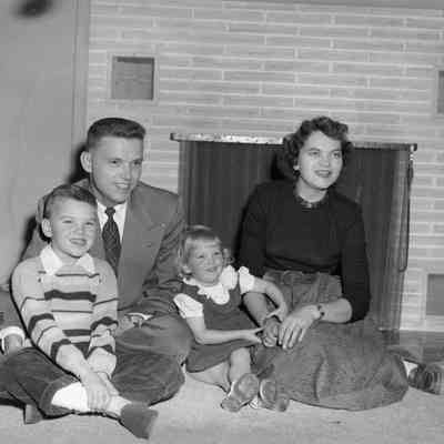 Family sitting by fireplace