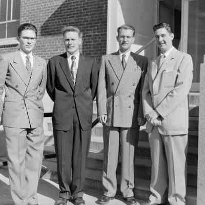 Four men in suits