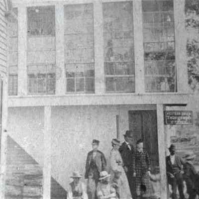 Group gathered at Dearborn store -- to watch a parade? c. 1890s: sign reads "Western Union Telegraph Office"