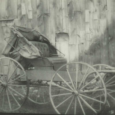 Buggy in front of barn.