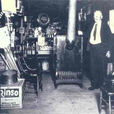 Charles Dearborn inside his store: note the chairs around the stove for the neighborhood regulars to sit and talk