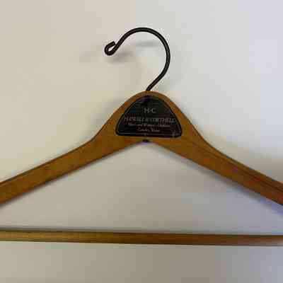 Hanger kept with jacket showing Haskell & Corthell, Men's & Women's Outfitters. Camden, Maine