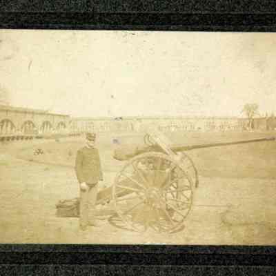 1 man next to artillery gun inside of fort