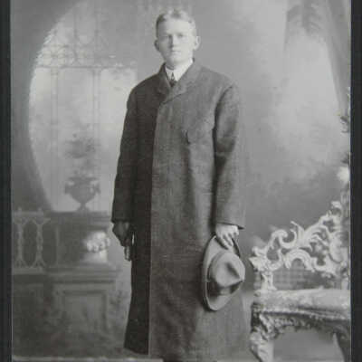 Portrait standing male full figure in civilian coat and hat
