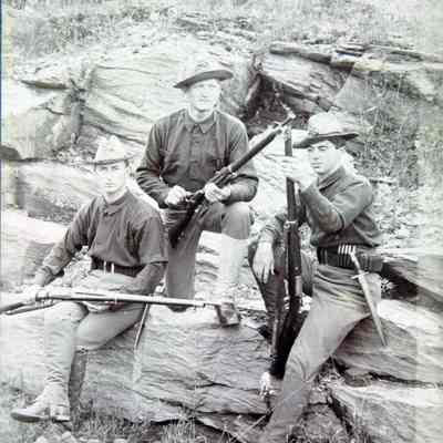 3 men in uniform with rifles