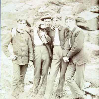 5 men standing outside in casual grouping