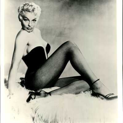 Photo - Lili St Cyr - B&W - Bustier and fishnets on rug, "lili St Cyr" printed in border on bottom left
