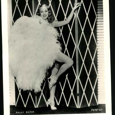Photo - Sally Rand - She has a giant fan covering most of her body. legs are visible. B&W