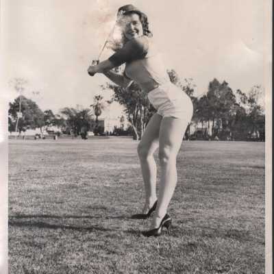 Photo - Linda Doll, B&W, posed outdoors w/ bat