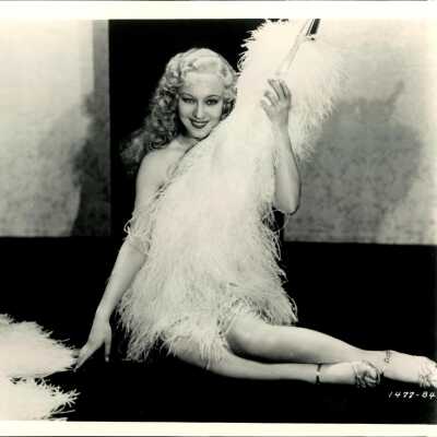 Photo - Sally Rand- sitting on ground with large fan-B&W