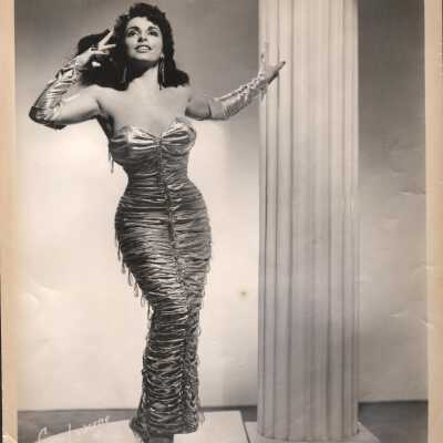 Photo - Carmella " The Sophia Loren of Burlesque" wearing ruched lame gown+ gauntlets