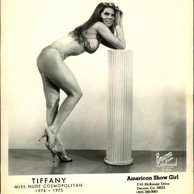 Photo - Tiffany Carter-B&W-Bra, g-string and sparkly high heels-leaning on pillar.
