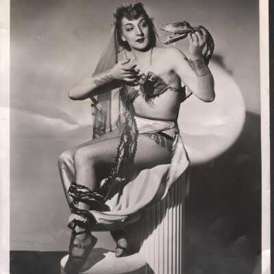 Photo - Melanie Merko B&W Holding serpent puppet, writing on back 'from Dixie Evans'