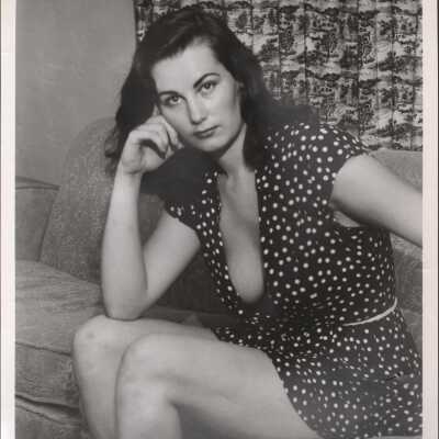 Photo - Sandy Baxter written on back B&W "S&S Film Productions" Casual clothes, seated on couch