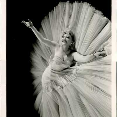 Photo - Sally Rand-Glossy Paper-wearing a dress with fabric that stands behind her
