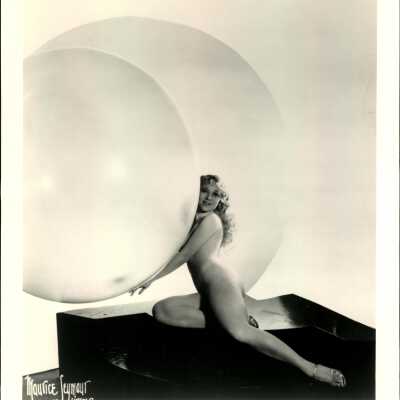 Photo - Sally Rand-Nude-sitting on shiny raised surface-two large bubbles-B&W