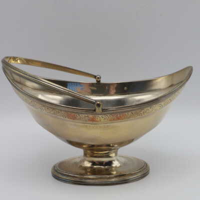 Silvertone footed canoe shaped pedestal bowl with a handle