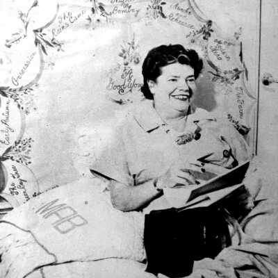 Mary Bromfield with the headboard in the back.