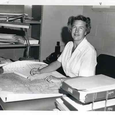 Ohio Geological Survey P099.3754: Jane L. Forsyth at her desk. This photograph is undated. The following information is tapped to the reverse of the photograph: Dr. Jane L. Forsyth, Pleistocene Geologist with the Division of Geological Survey. 
Archived by Lisa Van Doren
