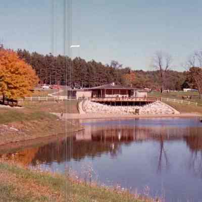 Blue Rock State Park - Cutler Lake and Park Bathhouse in Autumn, date unknown: The clear waters of Cutler Lake at Blue Rock State Park reflect the park's bathhouse and the changing autumn leaves.