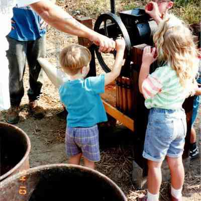 Children Operating Cider Press