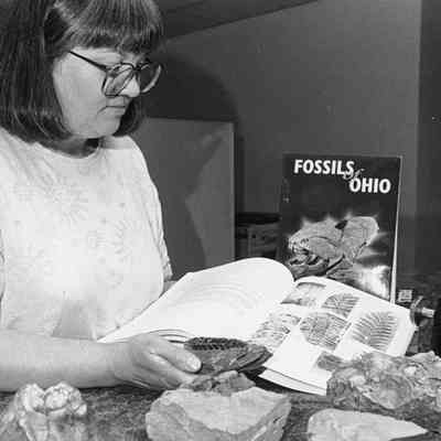 Ohio Geological Survey P102.4289: ODNR geologist Merrianne Hackathorn examines the fossil of a 300mya fern leaf discovered in eastern Ohio. Hackathorn is co-editor of Fossils of Ohio, a new 600 pg book detailing every type of fossil found in the state, where they are most likely to be found and how to identify them. 1997
Archived by Lisa Van Doren