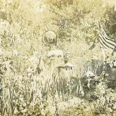 John Rogers in Lawn With Folk Art & Flag